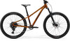 Mountain bike with orange frame and black components on a white background