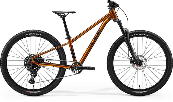 Mountain bike with orange frame and black components on a white background