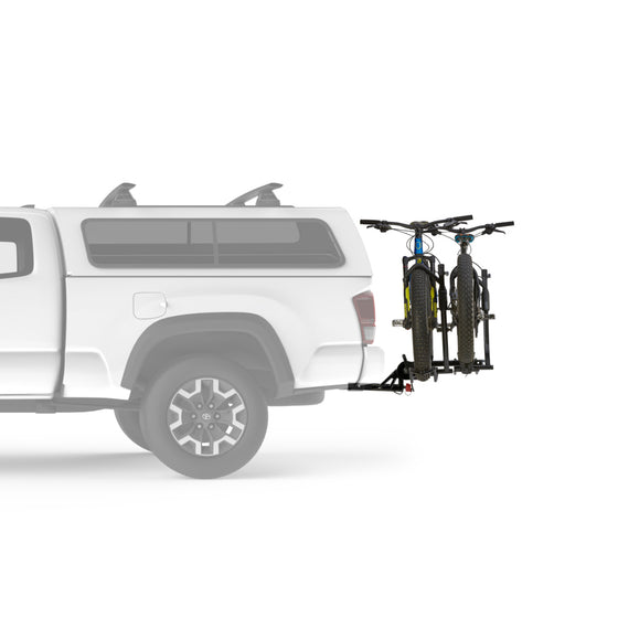 Yakima Holdup EVO hitch mounted vehicle bicycle rack with a 2 bike capacity  shown on the back of a ute